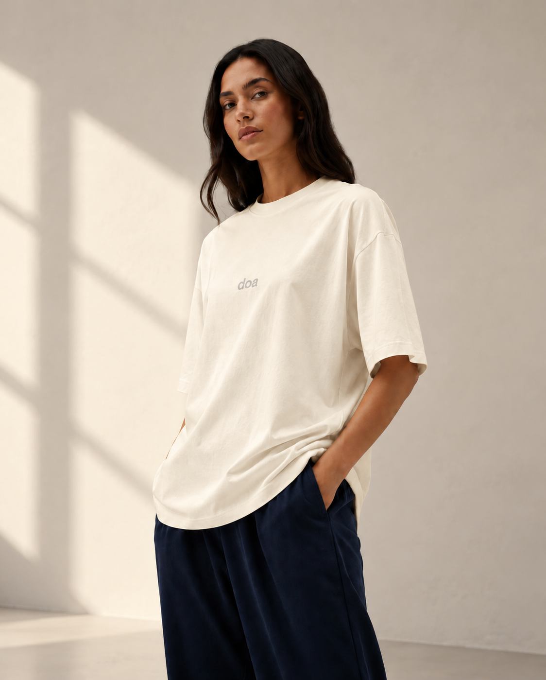 Woman wearing doa off-white oversized tee, relaxed fit close-up