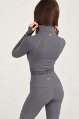 Back view of doa grey half-zip workout top with grey leggings